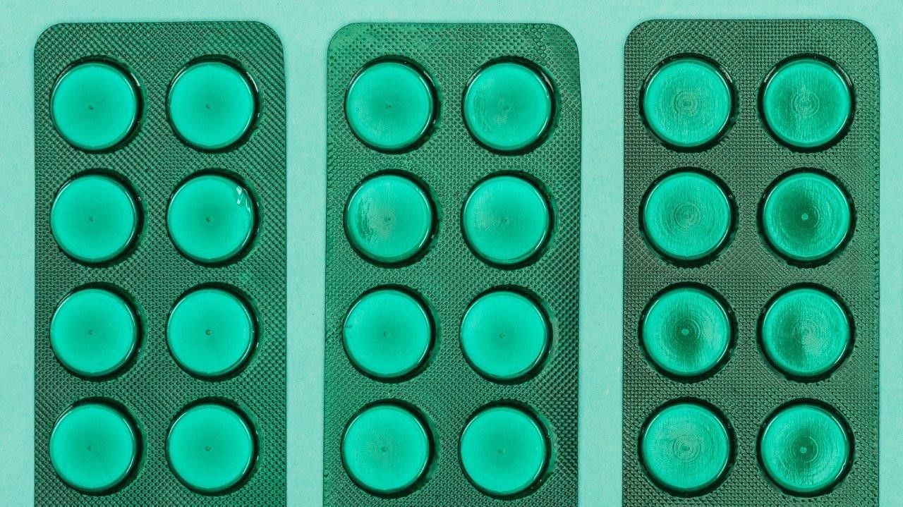 Pills on green background